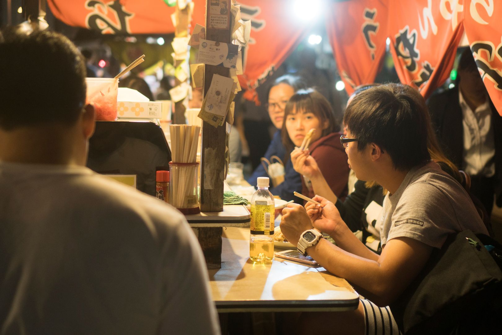 Japanese people gathered around a 'yatai' food stall in Fukuoka st night /via Getty Images.